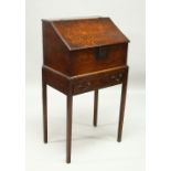 AN 19TH CENTURY OAK DESK ON STAND, with sloping front, fitted interior with small drawers, on a