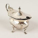 A SILVER MUSTARD POT, on curving legs with glass liner. 9.5cms wide.