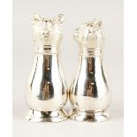 A PAIR OF CAST PLATE CAT PEPPERETTES. 11cms high.