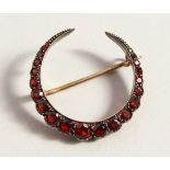 A GARNET SET CRESCENT BROOCH.