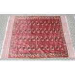 A LARGE TEKKE BOKHARA RUG, rust ground with four rows of eleven gulls, and broad end fringe. 135cm x