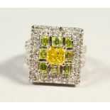 A VERY IMPRESSIVE 14CT WHITE GOLD RING, the central princess cut canary yellow colour diamond of