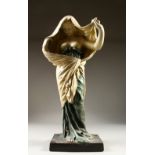 AN ART NOUVEAU STYLE POTTERY FIGURE OF A STANDING FEMALE SEMI NUDE. 63cms high.