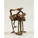 A SMALL BRONZE OF THREE CRANES. 5cms high.