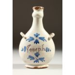 A SMALL MAIOLIC GUGLET/BOTTLE, painted with flowers and the name Joseph. 20cms high.