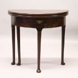 AN 18TH CENTURY MAHOGANY DEMI-LUNE FOLD-OVER CARD TABLE, with a small drawer, on cabriole legs. 77cm