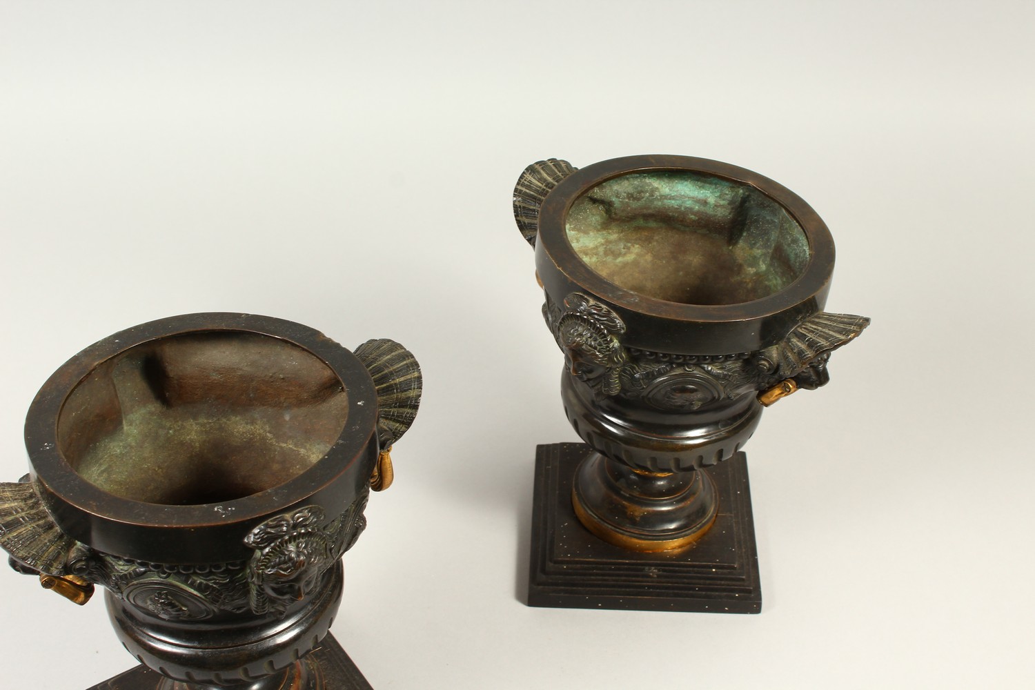 A PAIR OF 19TH CENTURY CAST BRONZE URNS, with lions mask and gilded handles, the body decorated with - Image 4 of 4