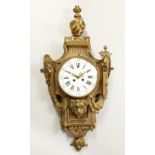 A FRENCH BRONZE CARTEL CLOCK, with urn finial and white enamel circular dial. 76cms high.