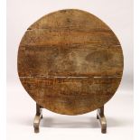 AN 18TH CENTURY AND LATER OAK CIRCULAR FOLDING TABLE, with plain supports and feet. 101cm diameter x