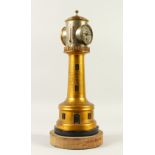 AN EDWARDIAN LIGHTHOUSE COMBINATION CLOCK, BAROMETER AND THERMOMETER, on a circular base. 46cm