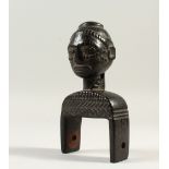 A TRIBAL CARVED BUST/PULLEY. 16cms high.