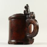 A GOOD 17TH-18TH CENTURY SCANDINAVIAN SYCAMORE PEG TANKARD, the lid and handle carved with an