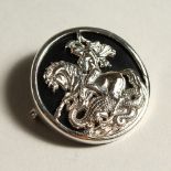 A SILVER AND ONYX "GEORGE AND THE DRAGON" BROOCH.