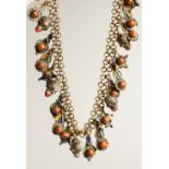 AN ISLAMIC SILVER METAL AND CORAL NECKLACE.