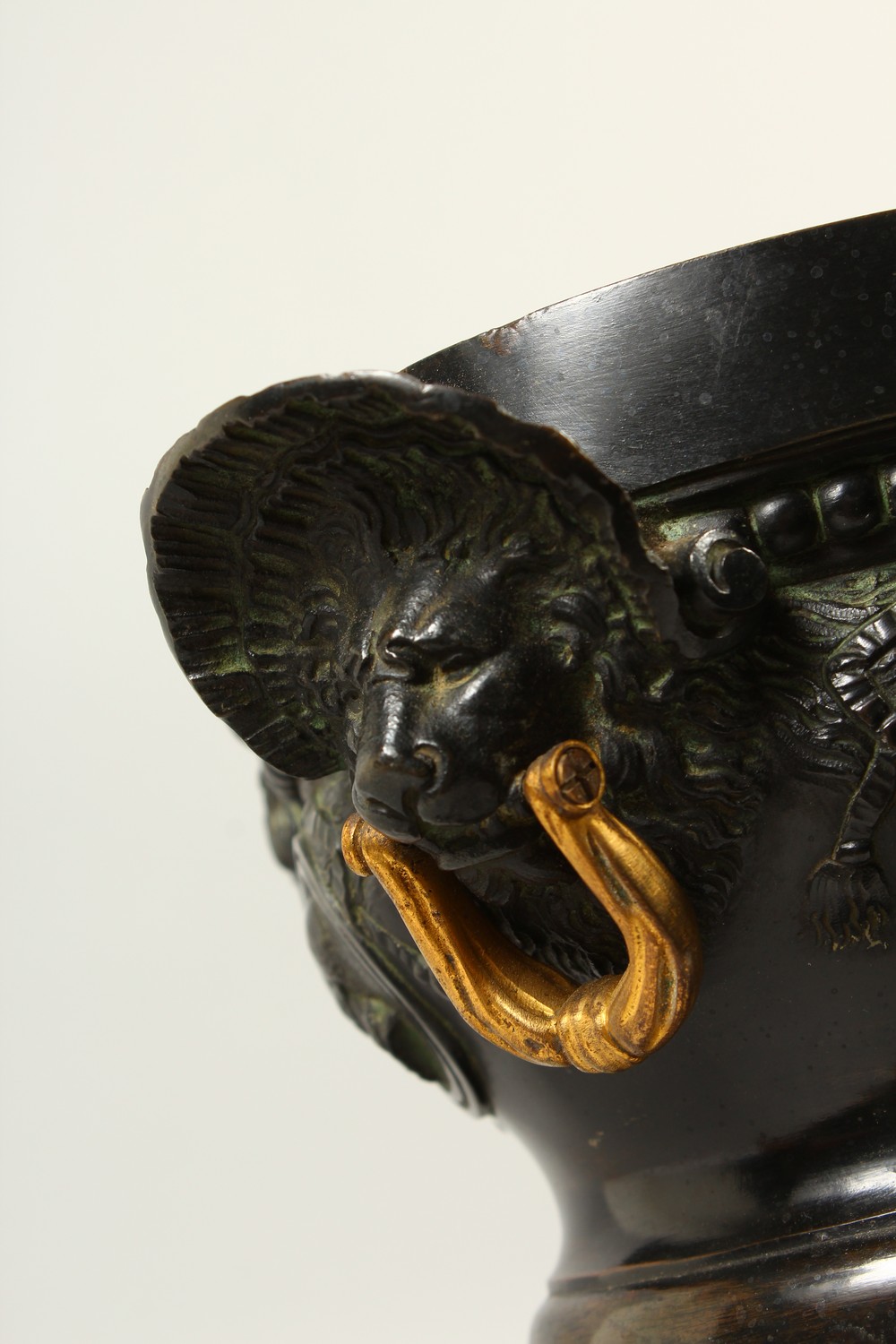 A PAIR OF 19TH CENTURY CAST BRONZE URNS, with lions mask and gilded handles, the body decorated with - Image 2 of 4