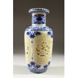 A CHINESE DOUBLE WALLED RETICULATED VASE, painted in blue with bands of flowers. 28cms high.