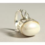 A SILVER AND PEARL RING.