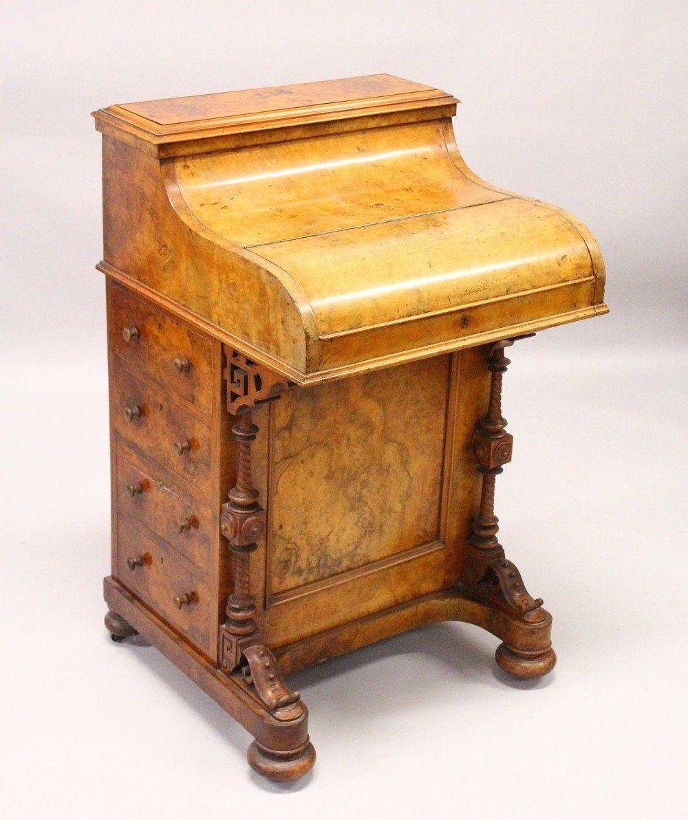 A GOOD VICTORIAN FIGURED WALNUT PIANO TOP DAVENPORT, with rising top, pull out writing surface, four