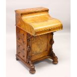 A GOOD VICTORIAN FIGURED WALNUT PIANO TOP DAVENPORT, with rising top, pull out writing surface, four