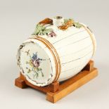 A CONTINENTAL MAJOLICA KEG, 14cm long, painted with roses with fruiting vines in relief.