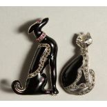 TWO SILVER AND ENAMEL RUBY SET DECO STYLE CAT AND DOG BROOCHES.