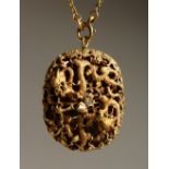 A CHINESE GOLD COLOURED PENDANT AND CHAIN.