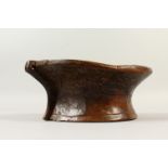 AN EARLY CARVED WOOD MORTAR. 28cm wide.