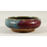 A SONG STYLE CIRCULAR BOWL, with blue and purple glazed decoration. 25cms diameter.