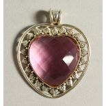 A SILVER AND PINK STONE HEART PENDANT.