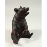 A CARVED WOOD "BLACK FOREST" BEAR TEA CADDY. 21cms high.