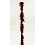 A HEAVY WOOD AFRICAN WALKING STICK with a head. 102cms long.
