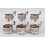 A SET OF SIX WHITE METAL CUP HOLDERS.