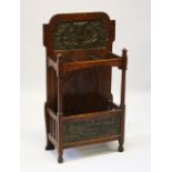 AN ART NOUVEAU OAK UMBRELLA STAND with copper panels. 104cms high x 57cms wide.