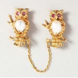 A GOOD PAIR OF GOLD, RUBY AND PEARL OWL BROOCHES.