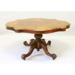 A VERY GOOD FIGURED WALNUT SHAPED TOP LOO TABLE with carved turned centre column support, ending