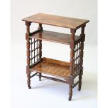 A 1920'S OAK OPEN BOOKCASE, on turned legs with castors. 59cms wide x 79cms high.