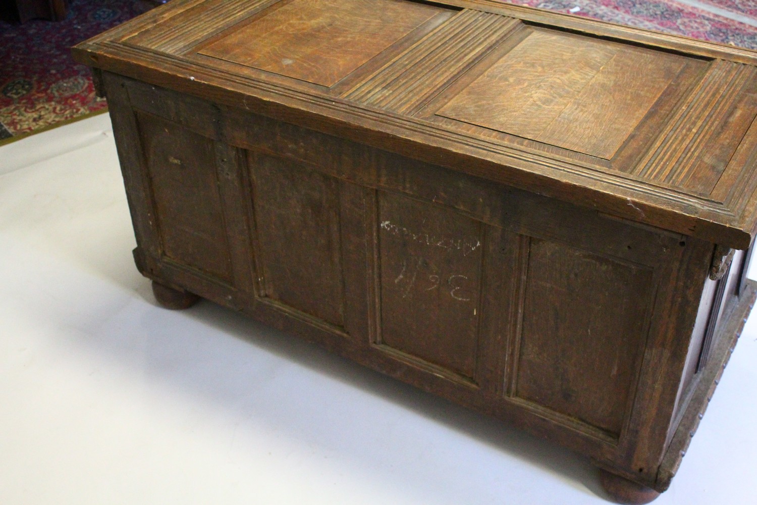 A LARGE 17TH-18TH CENTURY FRENCH OAK COFFER, with two plain panels to the top and two carved - Image 8 of 13