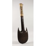 A POLYNESIAN CARVED WOOD CLUB with raffia handle. 18in long.