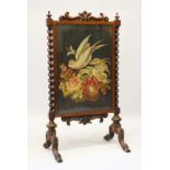 A VICTORIAN MAHOGANY FIRE SCREEN with Brussels needlework panel and barley twist supports.