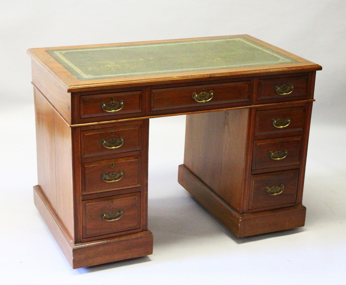 AN EDWARDIAN MAHOGANY PEDESTAL DESK, the top with leather writing panel, three drawers to the top