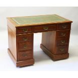 AN EDWARDIAN MAHOGANY PEDESTAL DESK, the top with leather writing panel, three drawers to the top