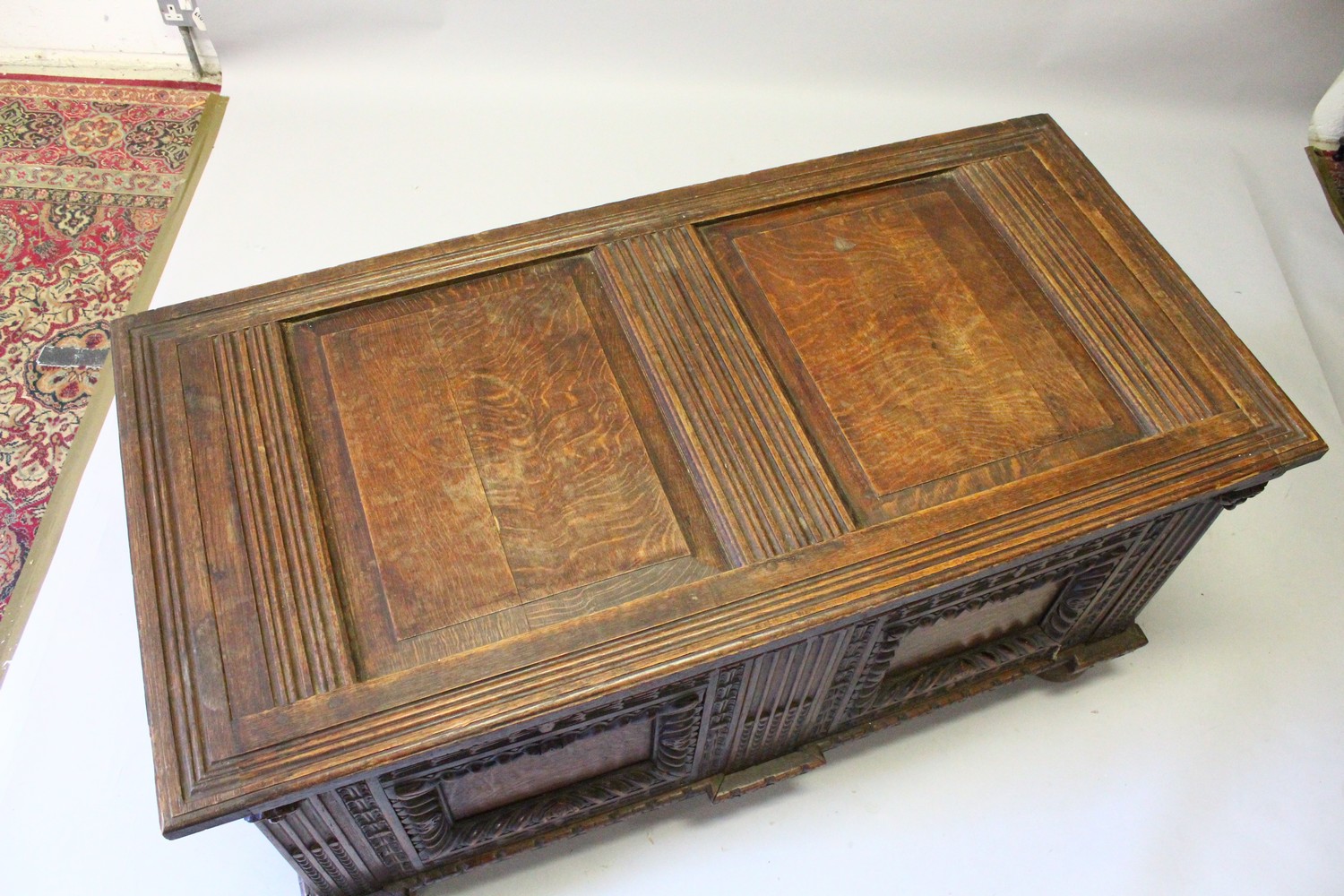 A LARGE 17TH-18TH CENTURY FRENCH OAK COFFER, with two plain panels to the top and two carved - Image 2 of 13