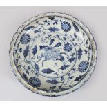 A CHINESE BLUE AND WHITE DISH with moulded rim. 20cms diameter.