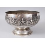 A 19TH CENTURY INDIAN SILVER METAL CIRCULAR BOWL, the sides repousse with a band of gods. 21cms