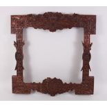 A GOOD 19TH CENTURY CHINESE HARDWOOD FRAME, deeply carved with scenes of dragons, bats lion dogs,