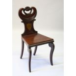A REGENCY MAHOGANY HALL CHAIR, with shaped back and solid seat.