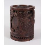 A BRONZE BRUSH POT, cast with figures in a landscape. 13.5cms.