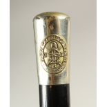 AN EBONISED WALKING STICK, with plated handle "Fight the Good Fight". 91cms long.