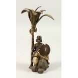 A VIENNA STYLE COLD PAINTED BRONZE OF A MAN SEATED BENEATH A PALM TREE. 23cms high.