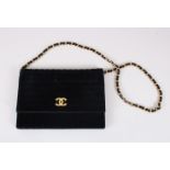 A CHANEL VELVET EVENING BAG, with gilt chain handle.